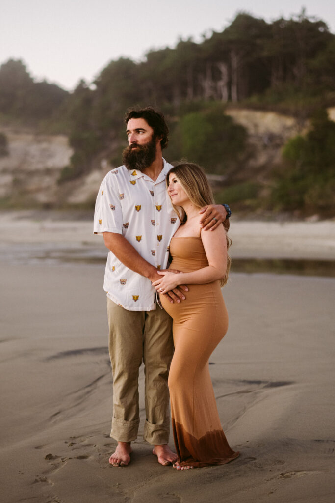 A young couples takes maternity photos at Seal Rock Recreation Site in Seal Rock, Oregon.