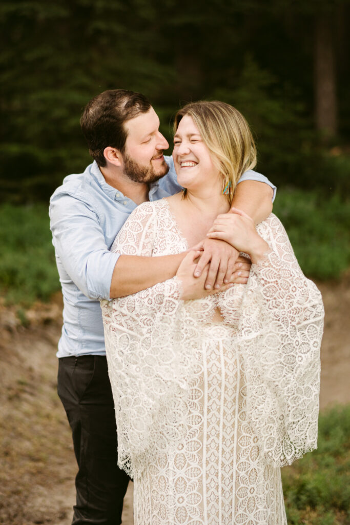 A bride and groom embrace on a hiking trail during their Mount Hood Meadows elopement.