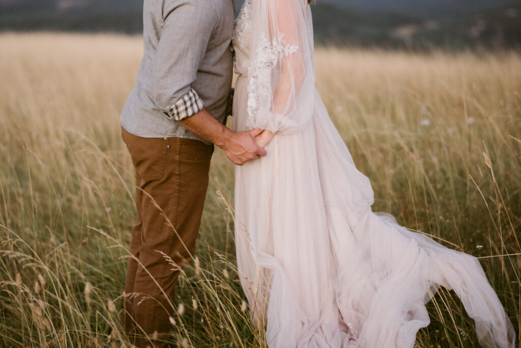 A husband and wife hold hands during their sunrise anniversary photos at Fitton Green in Corvallis, Oregon.