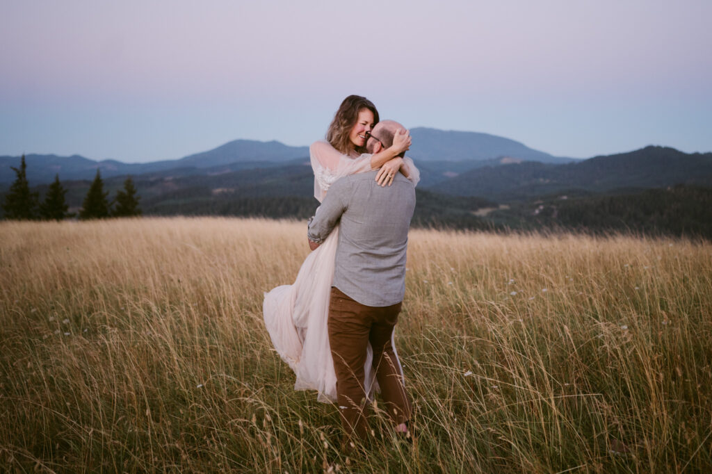 A man picks up a woman and spins her around at Fitton Green in Corvallis, Oregon.