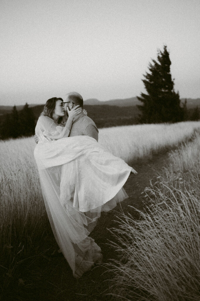 A black and white image of a man spinning a woman around at Fitton Green in Corvallis, Oregon.