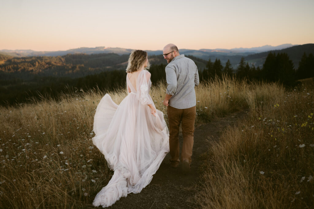 A man and woman run down a footpath at Fitton Green while taking anniversary photos at sunrise.