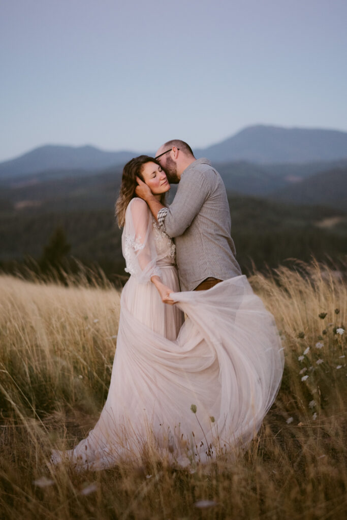 A husband and wife celebrate their anniversary with a lifestyle session at sunrise at Fitton Green in Corvallis. Mary's Peak can be seen in the background.