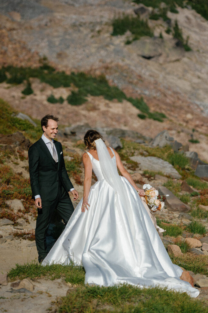 Elopement couple sharing a first look on the alpine terrain of Goat Rocks Wilderness, surrounded by soft light and rugged beauty.