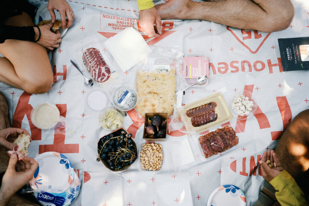 Rustic mountain picnic with figs, cured meats, nuts, and focaccia shared during a hiking elopement in Washington’s Goat Rocks Wilderness.