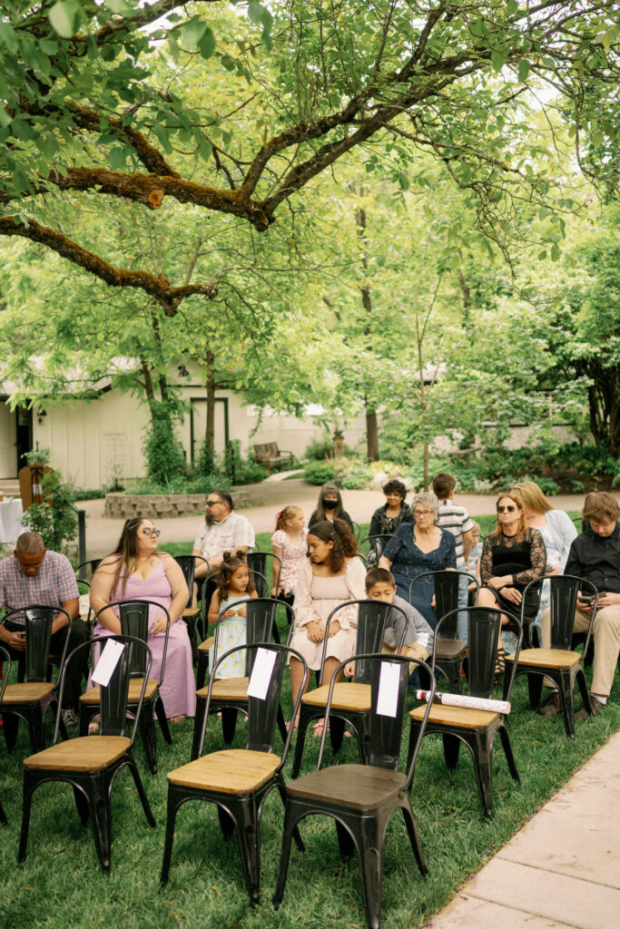 Guests begin to take their seats under the trees before the outdoor LGBTQ wedding ceremony at Applegate Ranch.