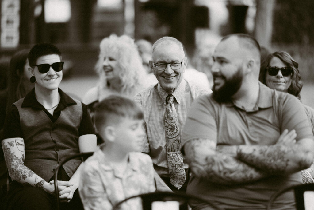 Guests laughing and chatting as they wait for the wedding ceremony to begin at Applegate Ranch in Grants Pass, Oregon.