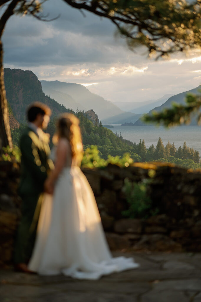 Softly focused portrait of the couple standing together at golden hour, overlooking the Columbia River Gorge.