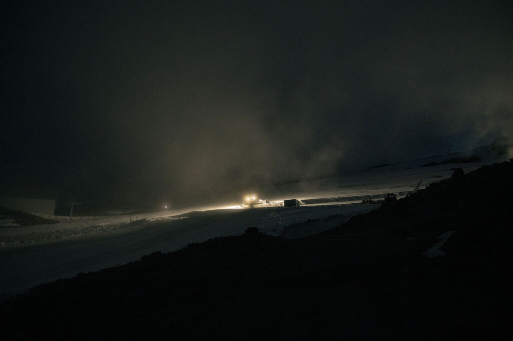 A Snowcat climbs through fog and darkness on Mount Hood, carrying guests up to Silcox Hut for a nighttime wedding celebration.