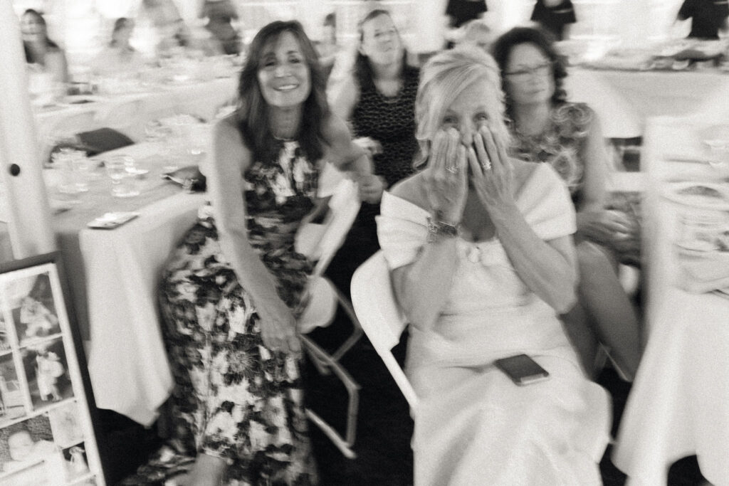 Mother of the bride reacting emotionally during toasts inside the tent at the White House on the Lake reception.