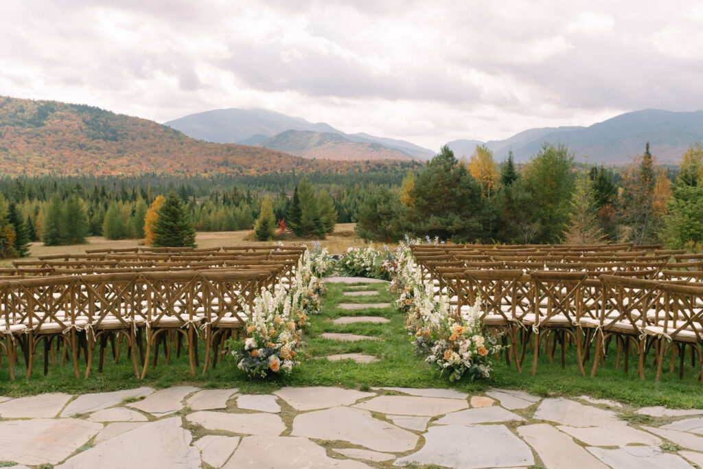 Ceremony aisle with florals overlooking Adirondack mountains at a Lake Placid private estate wedding