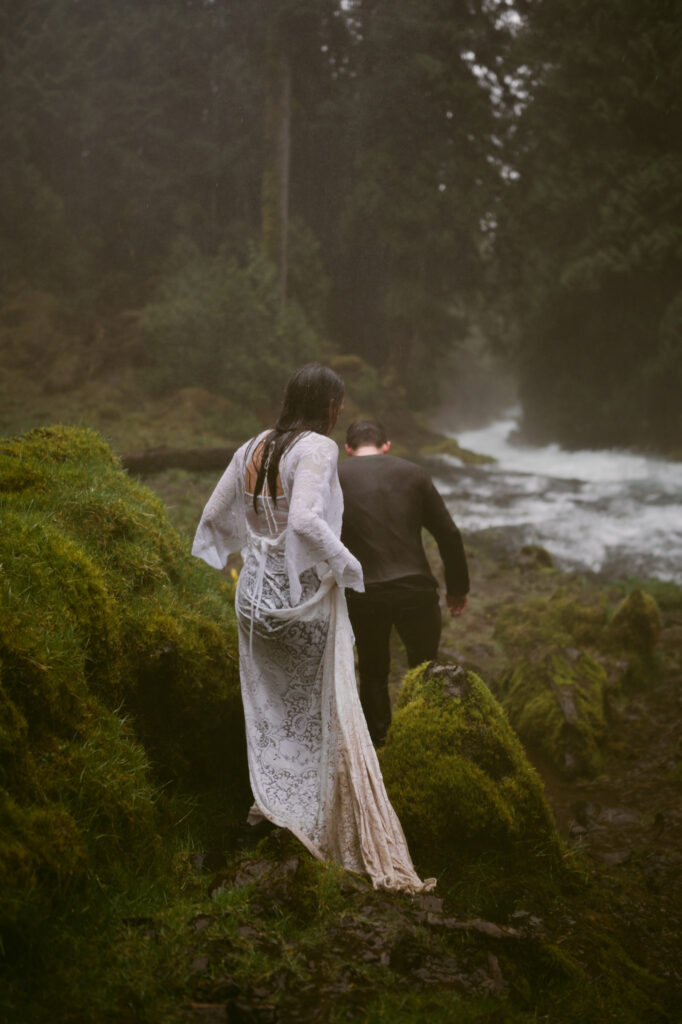 A detail shot of the bride's soaked and muddy dress as she walks away from the camera.