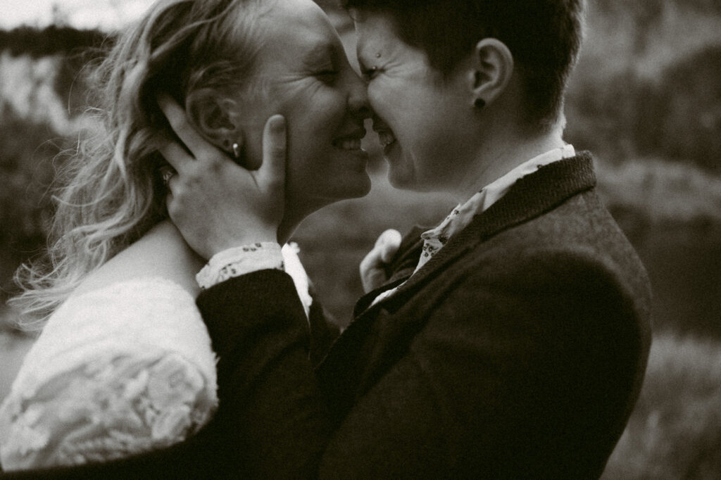 A close up, black and white image of two women kissing.
