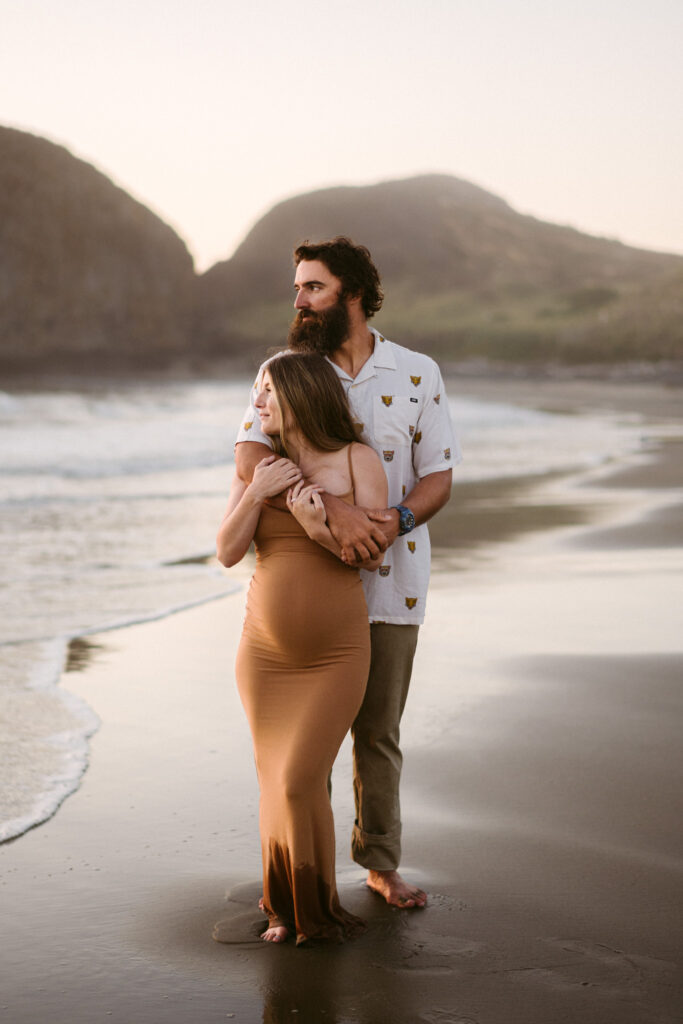 A young couples takes maternity photos at Seal Rock Recreation Site in Seal Rock, Oregon.