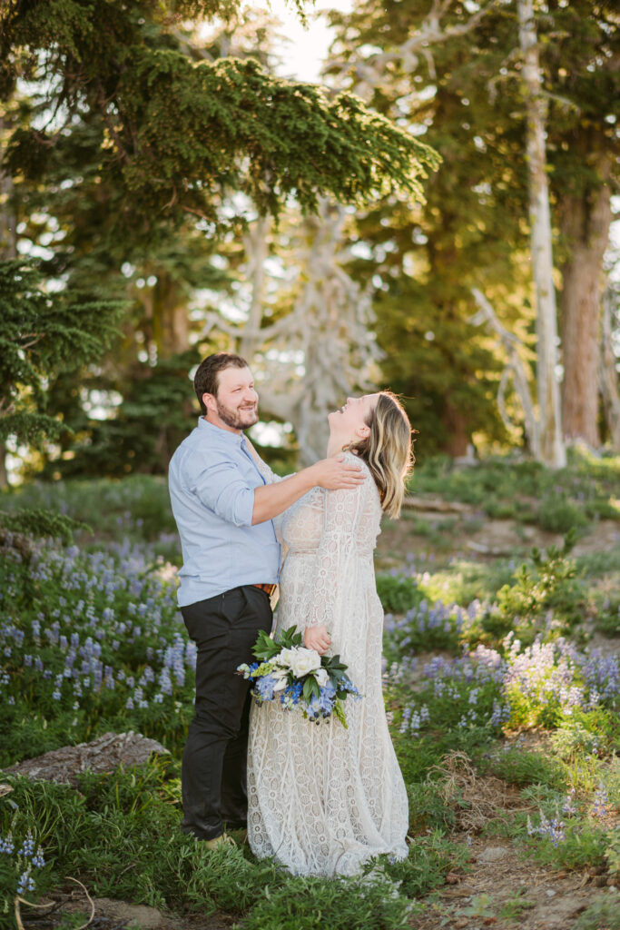 A bride and groom share a moment of laughter during their Mount Hood elopement.