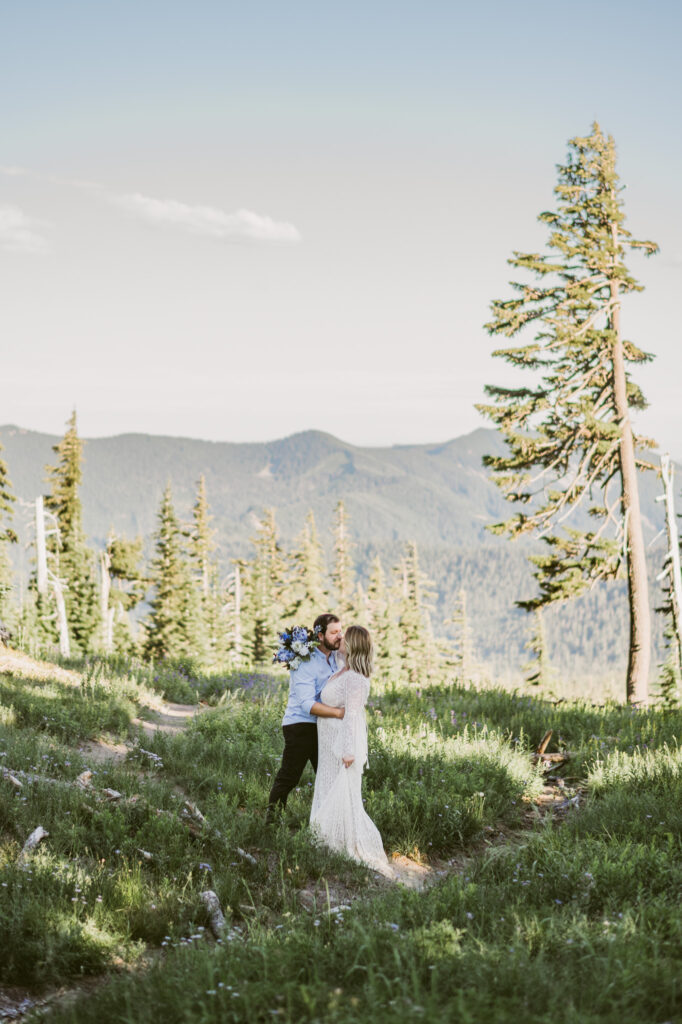 A bride and groom stop for a kiss during their Mount Hood elopement