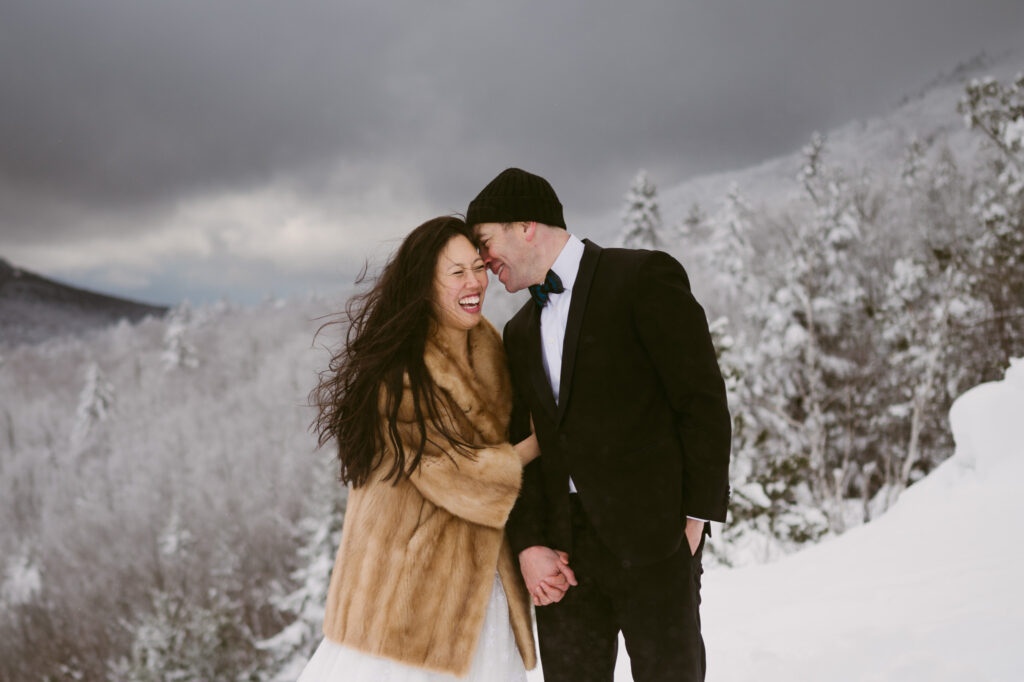 A caucasian man leans in close to an asian woman during their Adirondack elopement.