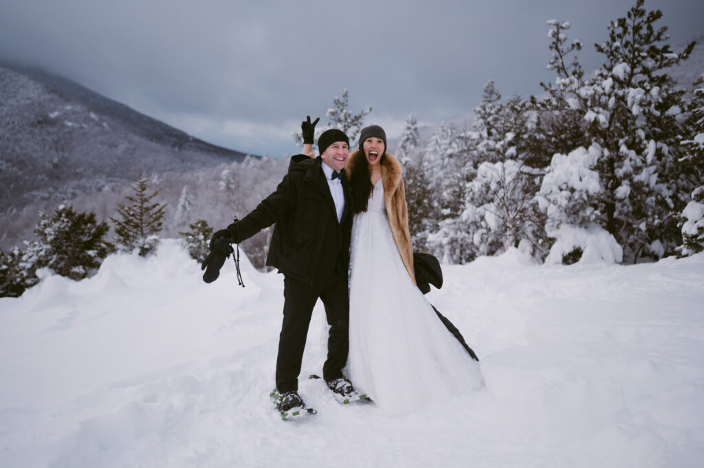 A bride and groom act silly as they celebrate their winter elopement in Lake Placid, NY.